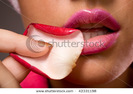 stock-photo-young-sensual-woman-touching-lips-with-rose-petal-42331198