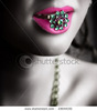 stock-photo-young-woman-holding-a-precious-green-stones-ring-in-her-pink-lips-23644192