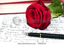 stock-photo-red-rose-and-love-letter-74958373