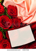 stock-photo-red-roses-with-white-greeting-card-at-fabric-33857908
