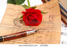stock-photo-red-silky-rose-with-vintage-pen-and-letter-2575866