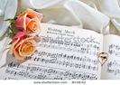 stock-photo-sheet-music-of-the-wedding-march-with-roses-and-rings-8038042