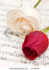 stock-photo-two-roses-on-the-musical-notes-page-12799702