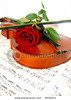 stock-photo-violin-with-bow-and-red-rose-on-music-sheet-9909214