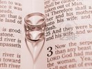 4553485-gold-wedding-bands-lying-on-a-page-of-the-bible-forming-shadow-hearts