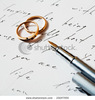 stock-photo-an-image-of-two-rings-and-a-pen-on-a-letter-23247955