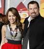 6399-actors-miley-cyrus-and-john-travolta-r-pose-at-the-premiere-of-their-animated-film-bolt-from-w